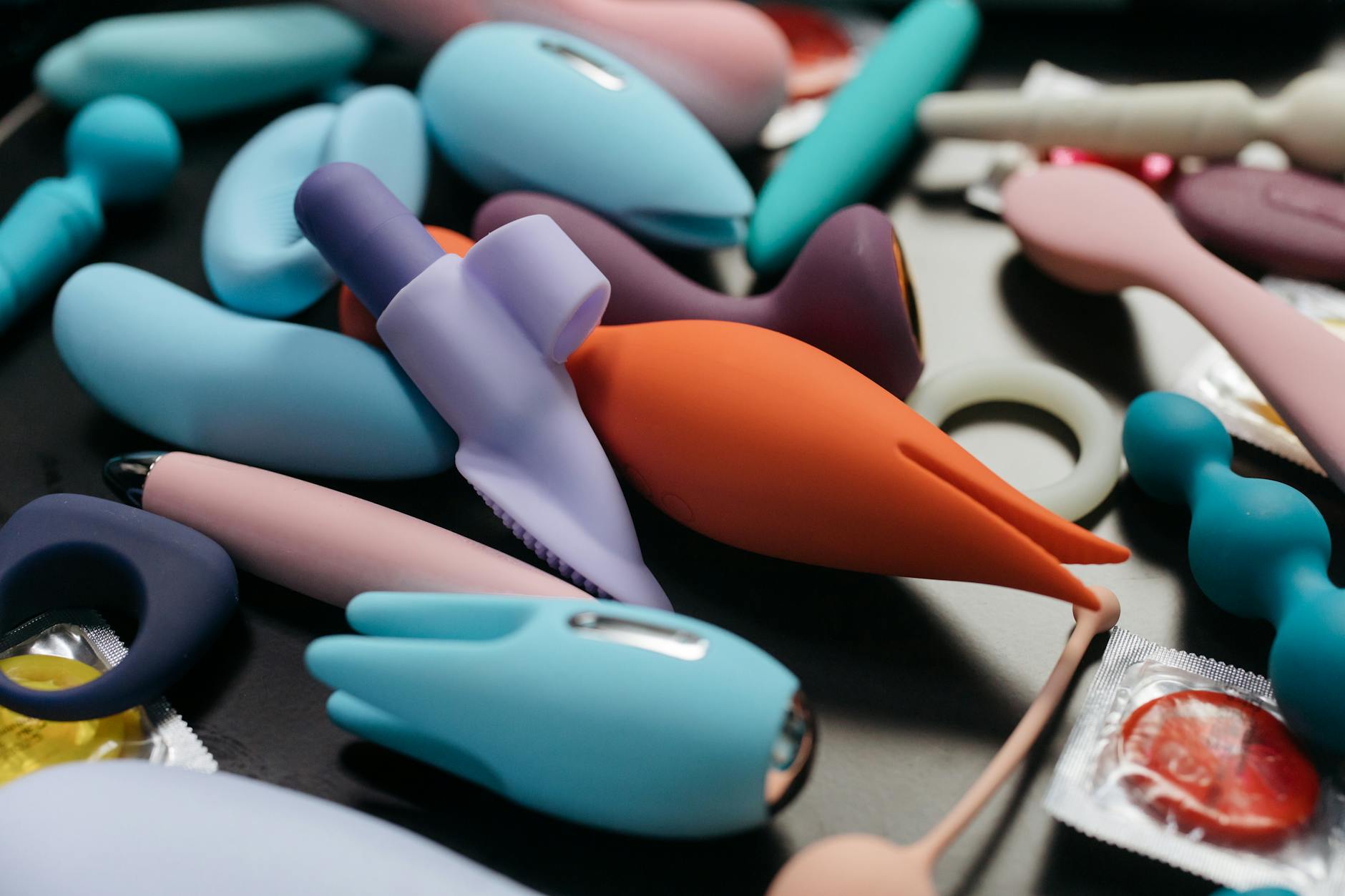 Prim-plan intim cu mâini ținând un vibrator elegant pe fundal violet